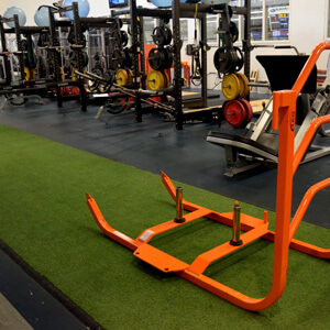 Fitness centre with a synthetic turf runway and sled
