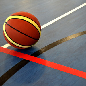 Basketball on blue woodgrain floor pattern and game lines