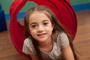Girl playing on the floor in kindergarten