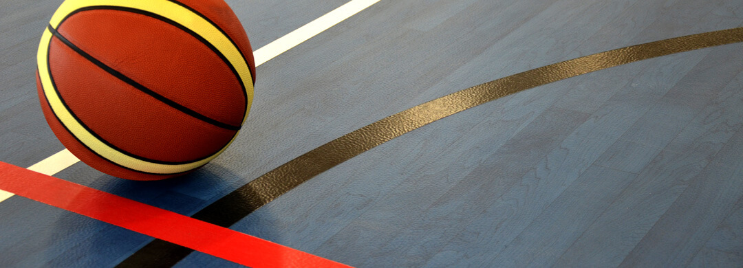Basketball on vinyl floor with painted game lines