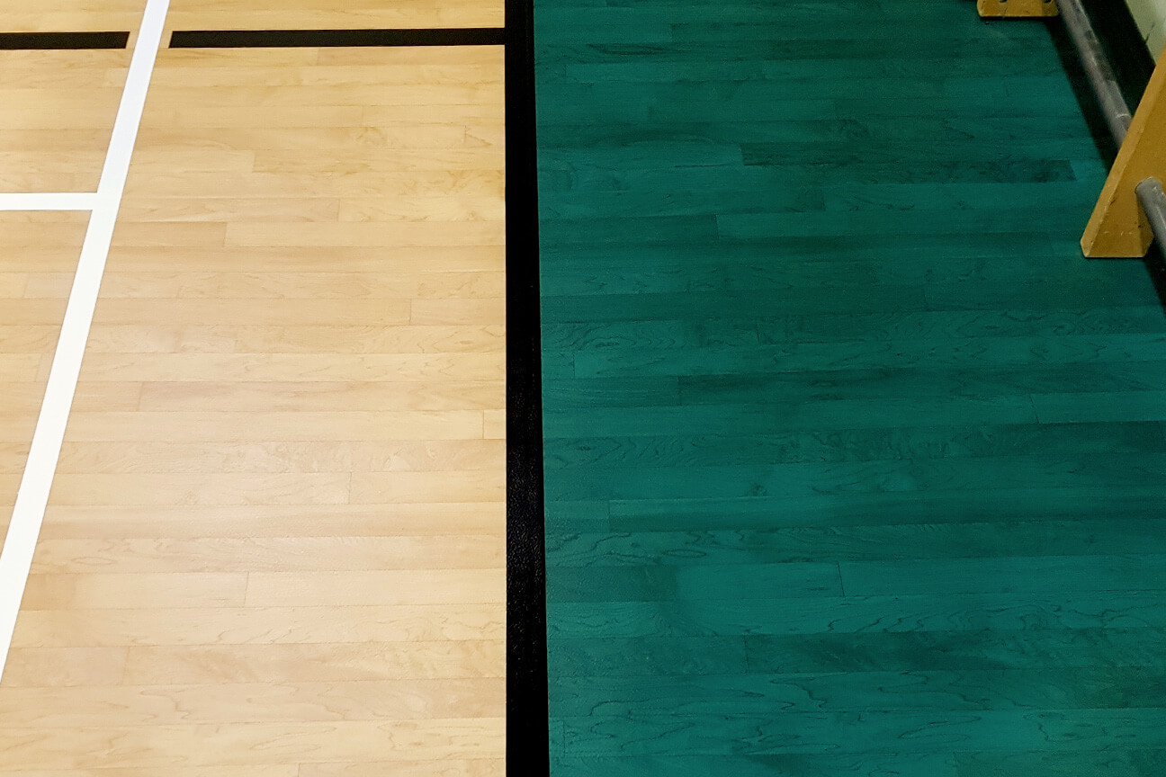 Aligning matching patterns between two adjoining colours of wood-look sports surfacing