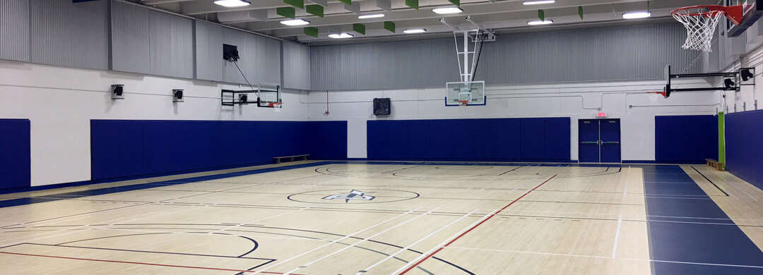 Gymnasium Omnisports light Maple coloured floor with game lines and blue perimeter