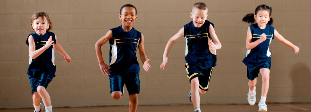 Kids running in a school gymnasium