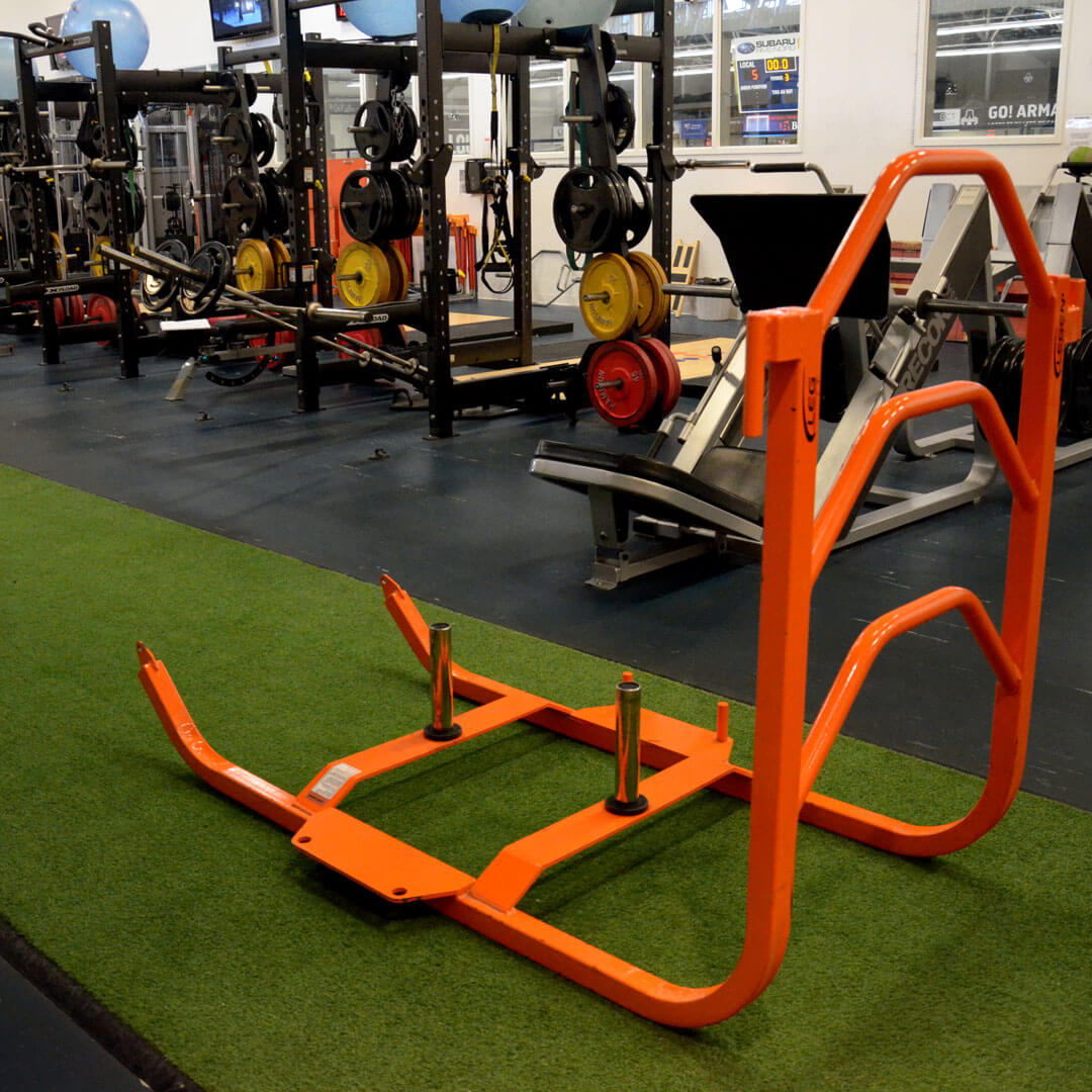 Sled with an artificial turf runway in a fitness centre