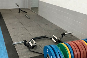 Rubber tiles for the impact of weighted plates in a fitness gym
