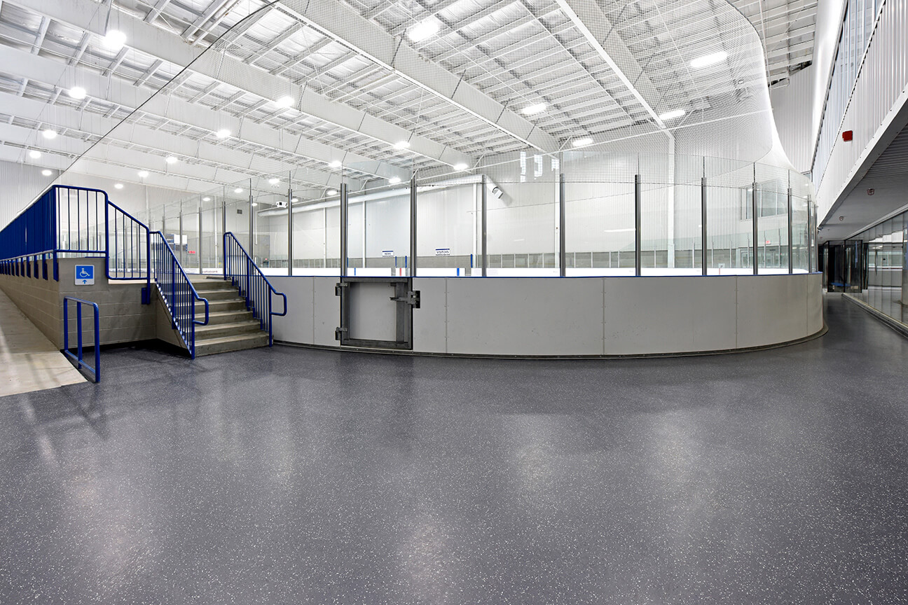 MaxFlor+ skate resistant flooring around rink perimeter in arena (Oakville, Ontario)