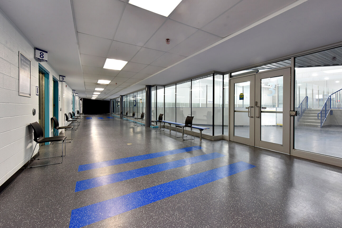 Two colours of MaxFlor+ skate resistant flooring in arena hallway (Oakville, Ontario)