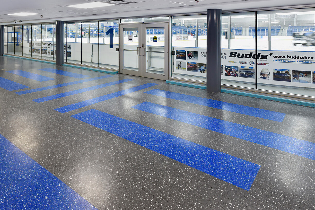Ice arena hallway with two colour design of rubber flooring (Oakville, Ontario)