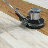 Refinishing a hardwood sports flooring