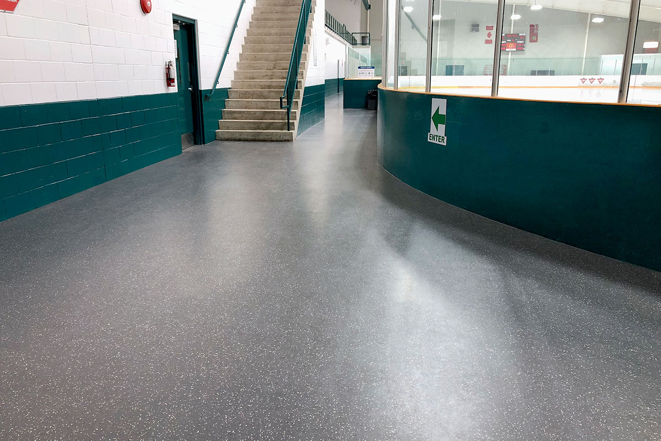 Rubber skate-resistant flooring around ice rink perimeter (Strathroy, Ontario)