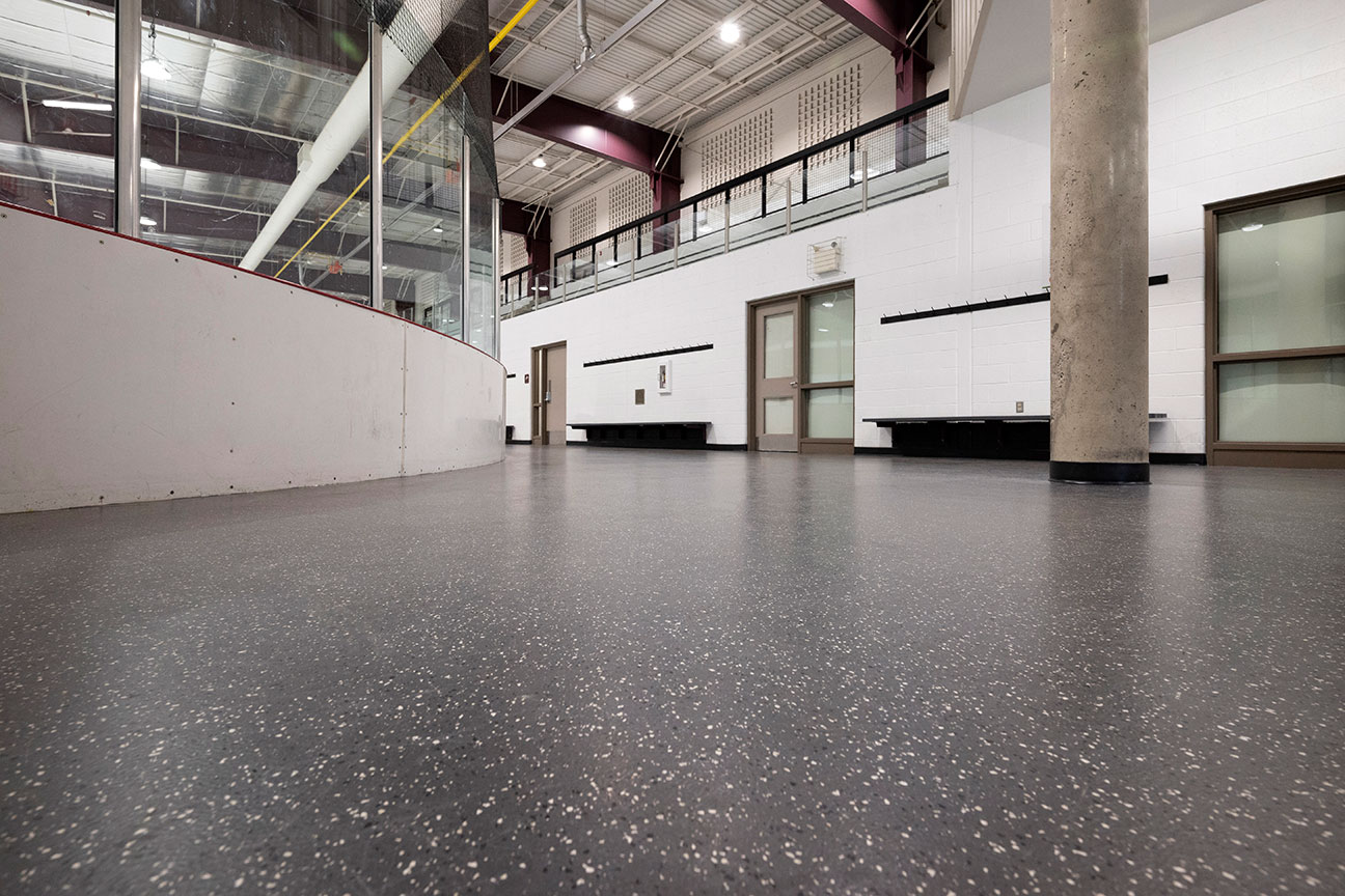 Rubber skate-resistant flooring in corner of ice rink perimeter (Richmond Hill, Ontario)