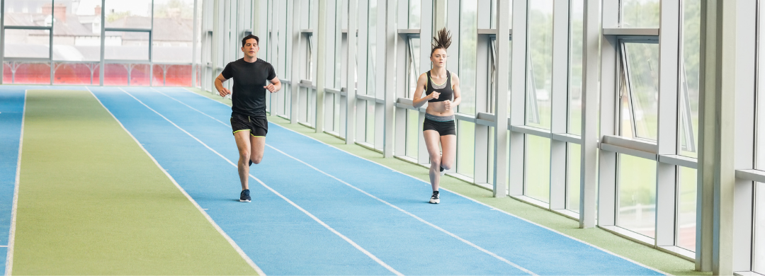 Athletes in action on an indoor running track