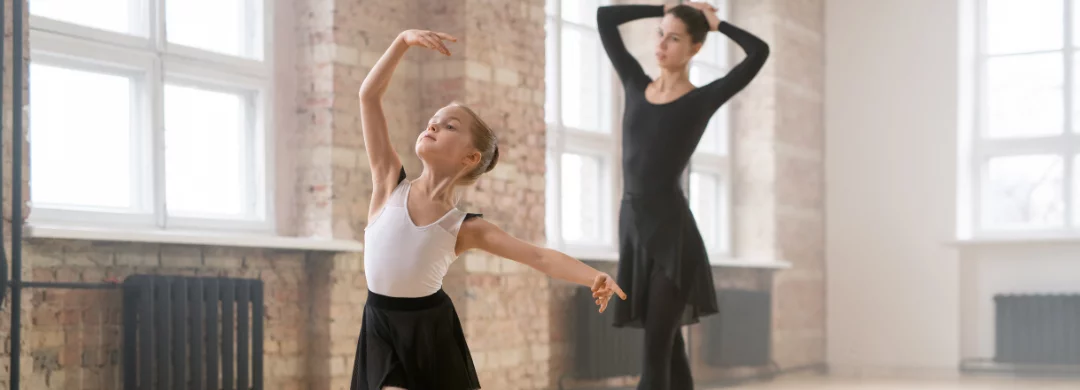 Young girl and woman dancing in a dance studio