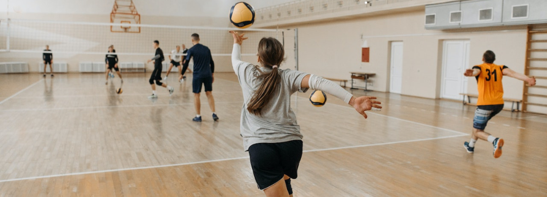 A player in a indoor volleyball court 